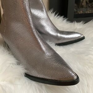 Western style silver tipped boots.